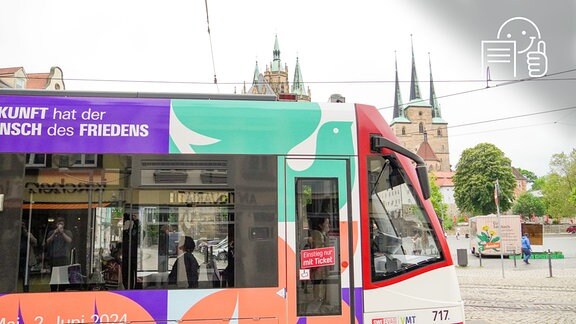 103. Katholikentag 2024 in Erfurt: Straßenbahn mit Werbung für den Katholikentag, im Hintergrund der Erfurter Dom