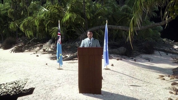 Ein Politiker hält eine Rede an einem Strand