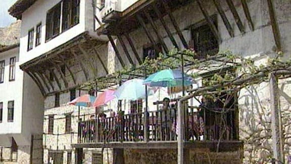 Eine Terasse mit Sonnenschirmen an einem Haus
