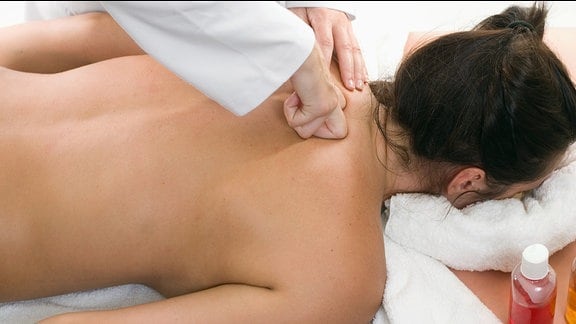 Eine Frau erhält einen tiefen Gewebe Massage.