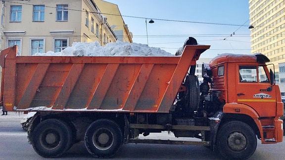 Ein LKW fährt Schnee aus der Stadt.