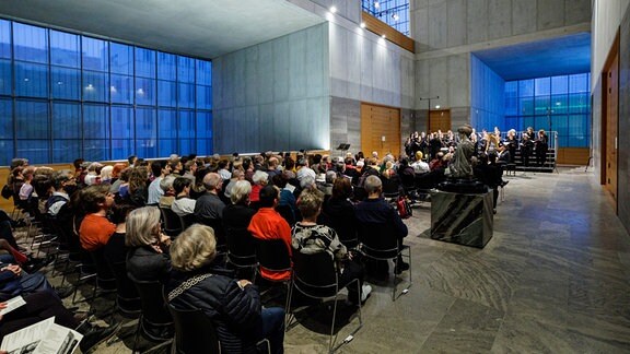 Konzertbesucher und MDR-Rundfunkchor unter der Leitung von Philipp Ahmann im Museum der bildenden Künste
