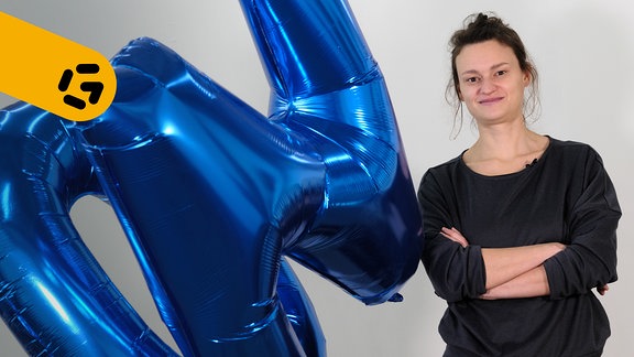Ein Porträt der Leipziger Installationskünstlerin Paula Wolber neben einem ihrer Kunstwerke; blaue Heliumballons mit den Buchstaben 'N' und 'O'.