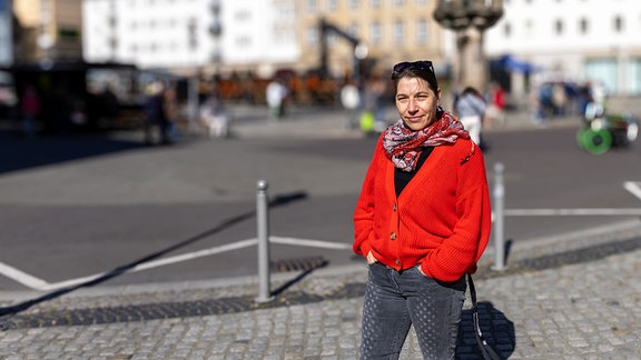 Eine Frau in roter Jacke und mit Sonnenbrille auf einem Fußweg: Kulturmanagerin Sindy Gärtner betreut das Rahmenprogramm beim Urban Dance Festival in Magdeburg