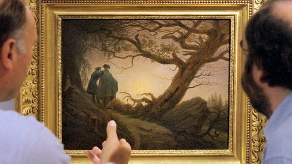 Zwei Männer stehen vor dem Bild "Zwei Männer in Betrachtung des Mondes" von Caspar David Friedrich.