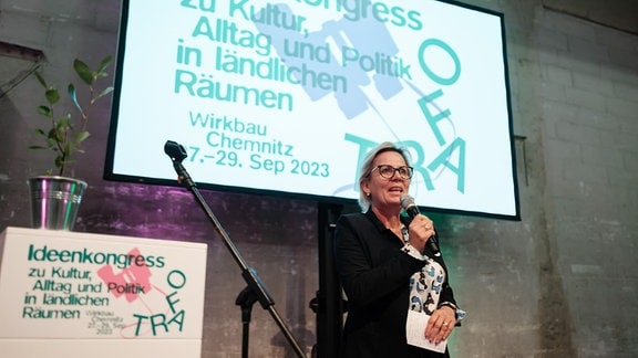Eine blonde, Ende 50 jährige Frau spricht auf einer Bühne in ein Mikrofon - es ist Sachsens Kulturministerin Barbara Klepsch.