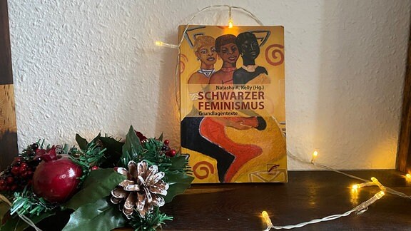 Das Buch "Schwarzer Feminismus" von Natasha A. Kelly neben Weihnachtsdeko.