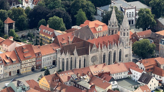 Blick von oben auf Mühlhausen, viele historische Gebäude, im Zentrum ist eine große Kirche.  