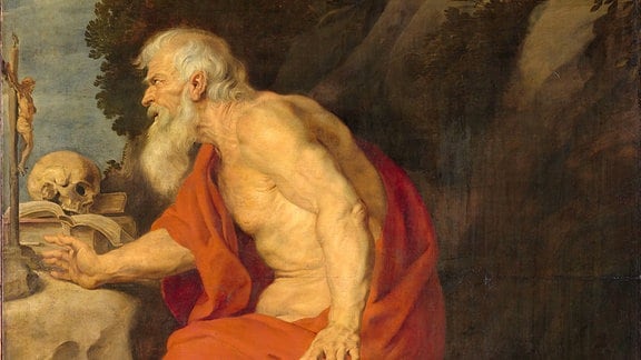 Gemälde Der Heilige Hieronymus, darauf zu sehen ist ein alter Mann, bekleidet mit einem roten Tuch, vor ihm liegt ein Löwe 