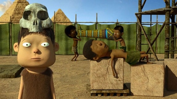 Zeichentrickfilm zeigt Arbeiter im alten Ägypten, im Hintergrund Pyramiden.