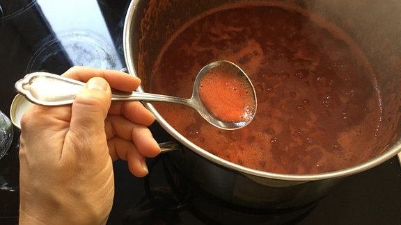 Schaum von Tomatenmarmelade abschöpfen