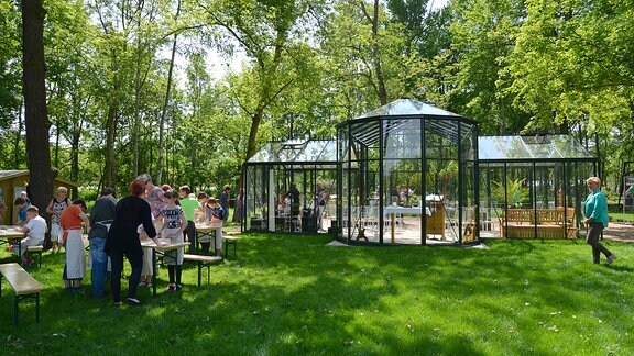 Gläserner Pavillon in einem Park.