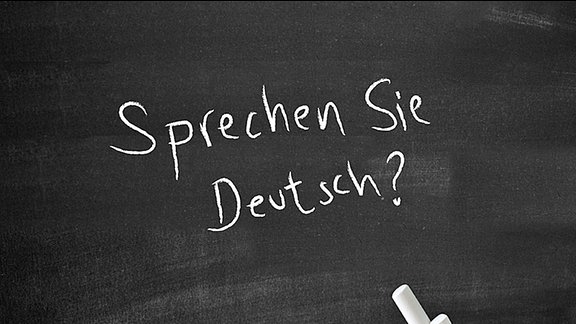 "Sprechen Sie deutsch" steht auf einer Tafel