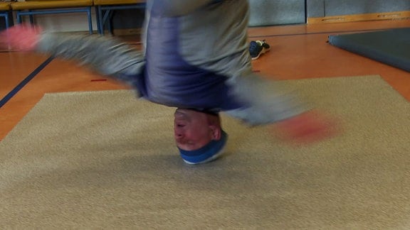 Ein Breakdancer dreht sich auf dem Kopf.