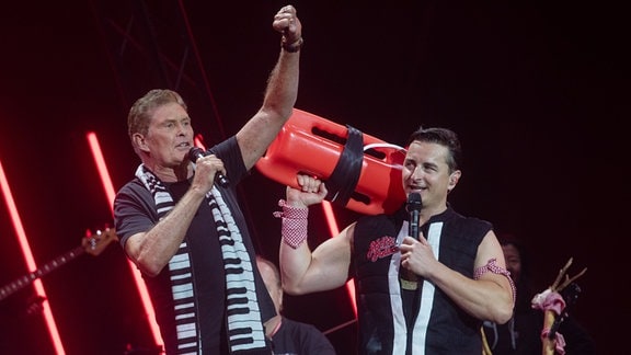 Andreas Gabalier (r) steht bei seinem Konzert im Olympiastadion mit David Hasselhoff auf der Bühne. Bei der Show des österreichischen Musikers traten auch Überraschungsgäste auf.