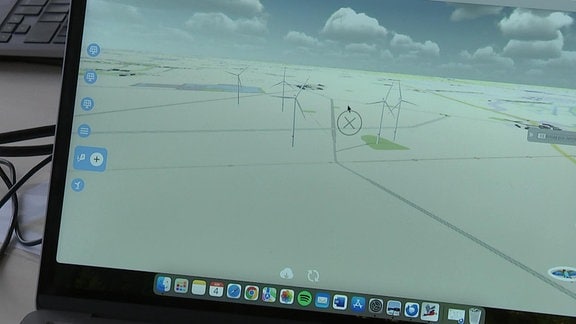 Bildschirm mit einer abstrakten Landschaft, auf der Windräder platziert werden