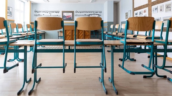 Stühle auf den Tischen eines leeren Klassenzimmers