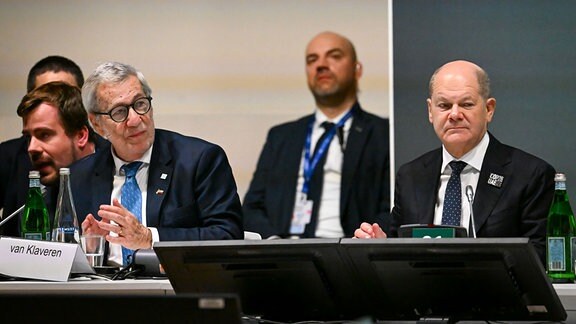 Bundeskanzler Olaf Scholz (r, SPD) und Alberto van Klaveren Stork (3.v.l), AuÃenminister von Chile, sitzen während der Weltklimakonferenz der Vereinten Nationen (COP28) bei der Veranstaltung "Climate Club Full Launch" nebeneinander.