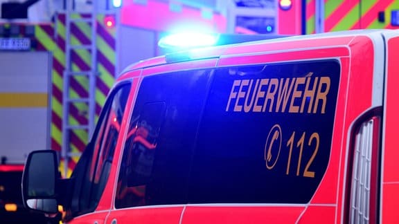 Fahrzeuge der Feuerwehr sind eingeschaltetem Blaulicht im Einsatz.