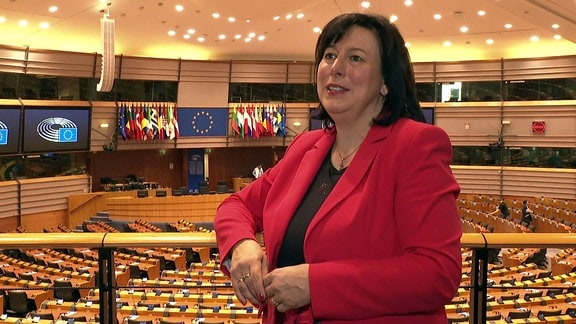 Eine Frau lehnt an einem Geländer im Europaparlament.