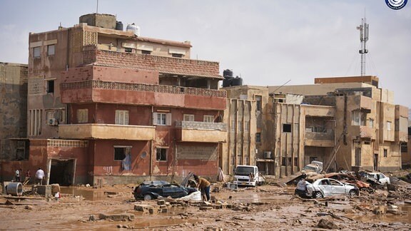 Auf diesem von der libyschen Regierung zur Verfügung gestellten Bild liegen Autos und Trümmer in einer Straße in Darna, Libyen, nachdem sie durch starke Regenfälle überflutet wurde.