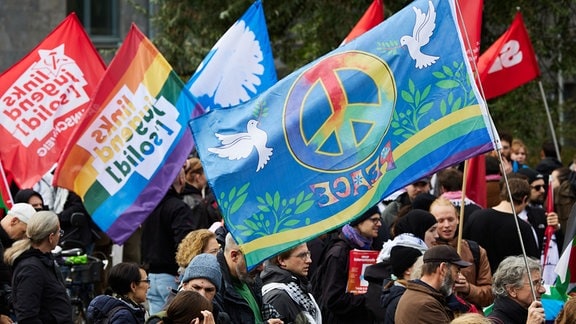 Zu einer Auftaktkundgebung zu einer Friedensdemonstration versammeln sich einige Menschen am Gleisdreieck Park.