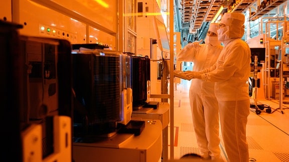 Mitarbeiterinnen des Chipkonzerns Infineon arbeiten im Reinraum der Chipfabrik. 