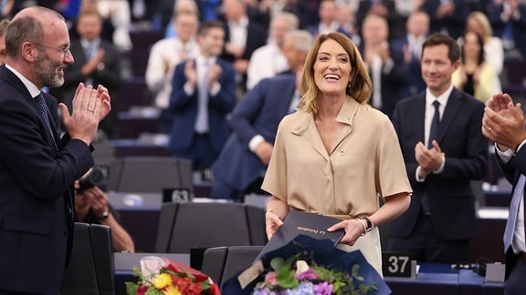 Parlamentspräsidentin Roberta Metsola vom Mitte-Rechts-Bündnis EVP wird während der Plenarsitzung des Europäischen Parlaments zu ihrer Wiederwahl beglückwünscht.