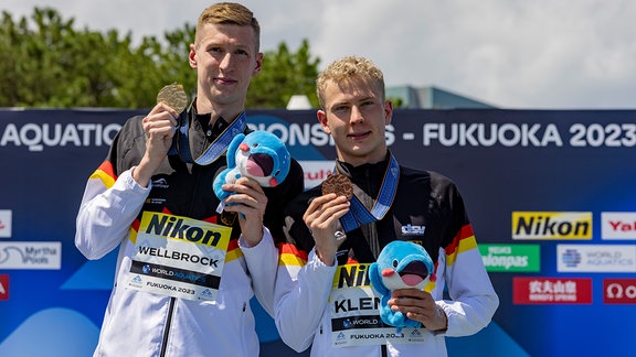 Florian Wellbrock und Oliver Klemet zeigen ihre Medaillen.