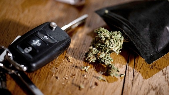 Cannabisblüten liegen auf einem Tisch neben einem Autoschlüssel.
