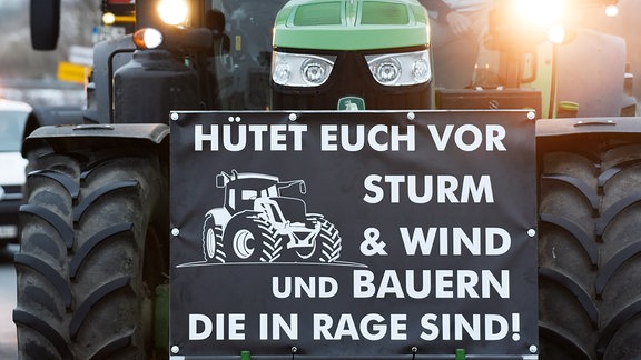 "Hütet euch vor Sturm & Wind und Bauern, die in Rage sind!", steht auf einem Traktor.