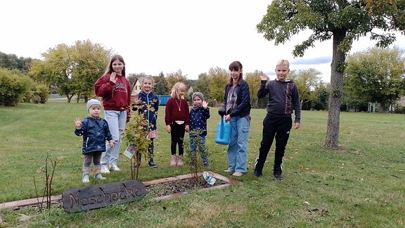 Kinder stehen auf einer Wiese