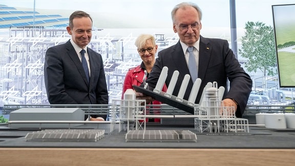 Reiner Haseloff (CDU, r), ergänzt im Beisein von Anke Kaysser-Pyzalla, Vorsitzende des DLR-Vorstands, und Volker Wissing (FDP), das Modell einer Anlage für Power-to-Liquid-Kraftstoffe im Chemiepark Leuna.