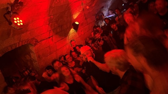 Menschen in einem Keller bei rotem Licht