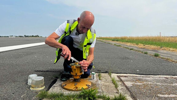 Ein Mann arbeitet auf einer Start- und Landebahn