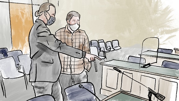 Ein Anwalt zeigt einem Zeugen den Gerichtssaal