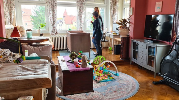 Zwei Frauen in einem Zimmer mit Wickeltisch und Spielsachen