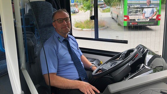 Ein Busfahrer im Führerstand