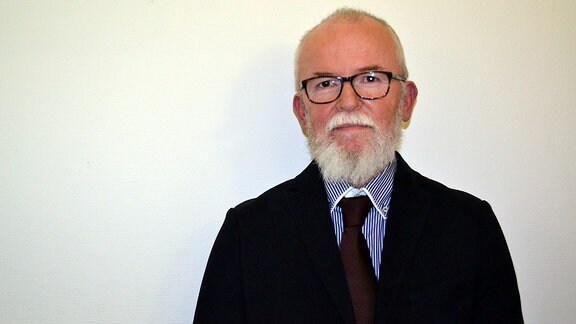 Portraitfoto eines Mannes mit Bart und Brille