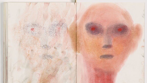 Eine farbige Skizze in einem Notizbuch mit einem Gesicht