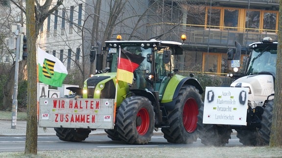 Traktoren mit Protestbannern und Fahnen auf der Peterburger Straße in Dresden