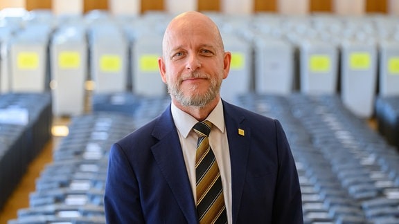 Markus Blocher, Kreiswahlleiter, steht vor Beginn der Sitzung des Kreiswahlausschusses im Festsaal im Rathaus vor Wahlurnen und Wahlkoffern. 