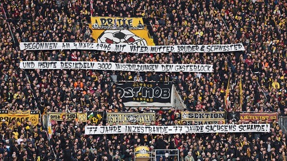 Fans von Dynamo Dresden zeigen ein diskriminierendes Transparent.
