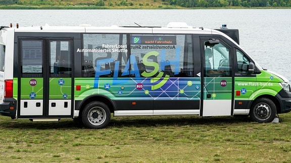 Ein Bus-Shuttle mit der Aufschrift FLASH steht am Ufer des Schalditzer Sees bei Leipzig