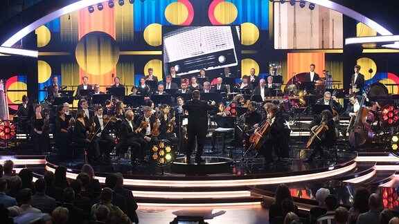 Musiker des MDR-Sinfonieorchesters spielen bei einer Live-Übertragung in einem Fernsehstudio.