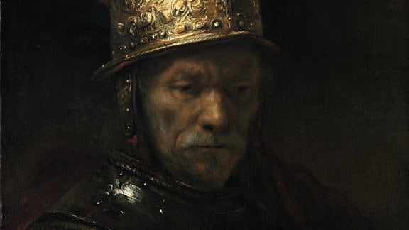 Der Mann mit dem Goldhelm in der Rembrandt-Ausstellung in Leipzig: dunkles Porträtbild eines älteren Mannes mit goldenem Helm, der nach unten blickt