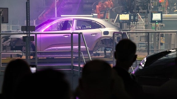 Gäste sitzen während des Festakts zum Produktionsstart des vollelektrischen Porsche Macan im Werk Leipzig. 