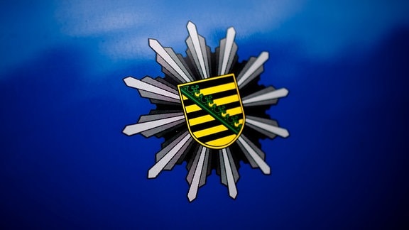 Das Logo der Polizei Sachsen klebt am Donnerstag (22.09.2011) auf dem blauen Lack eines Polizeifahrzeuges vor dem Polizeirevier "Polizeidirektion Dresden" in Dresden. 