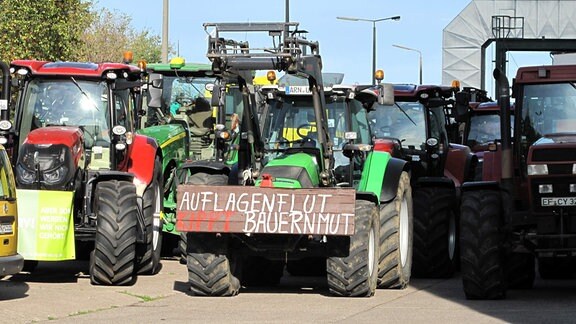 Traktor mit Schild "Auflagenflut kippt Bauernmut"