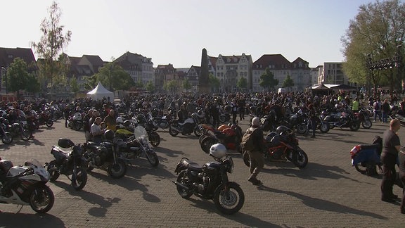 Sehr viele Motorradfahrerinnen und Motorradfahrer auf einem weitläufigen Platz